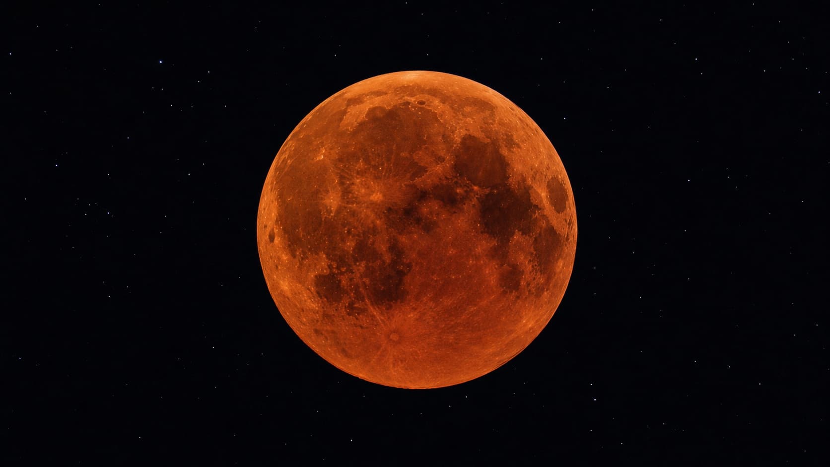 A blood moon glowing deep coppery red during a total lunar eclipse.