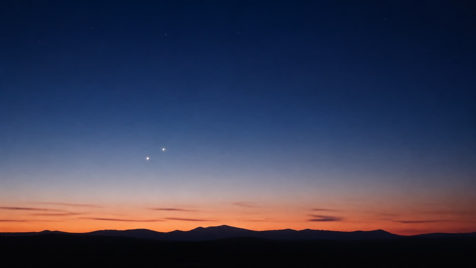 Two bright planets visible just above the horizon during evening twilight