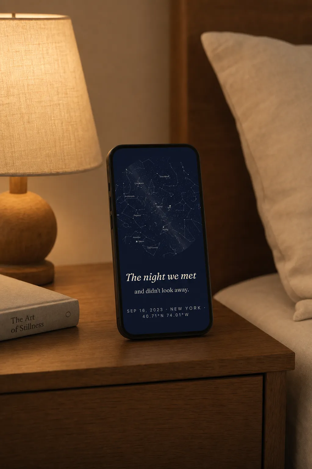 A phone on a nightstand showing a SkyWhen star map wallpaper